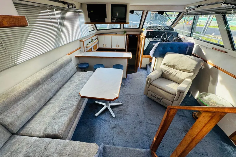 Slide: The Image of Interior of a 1991 Sea Ray 380 Aft Cabin yacht with seating and helm. - 21
