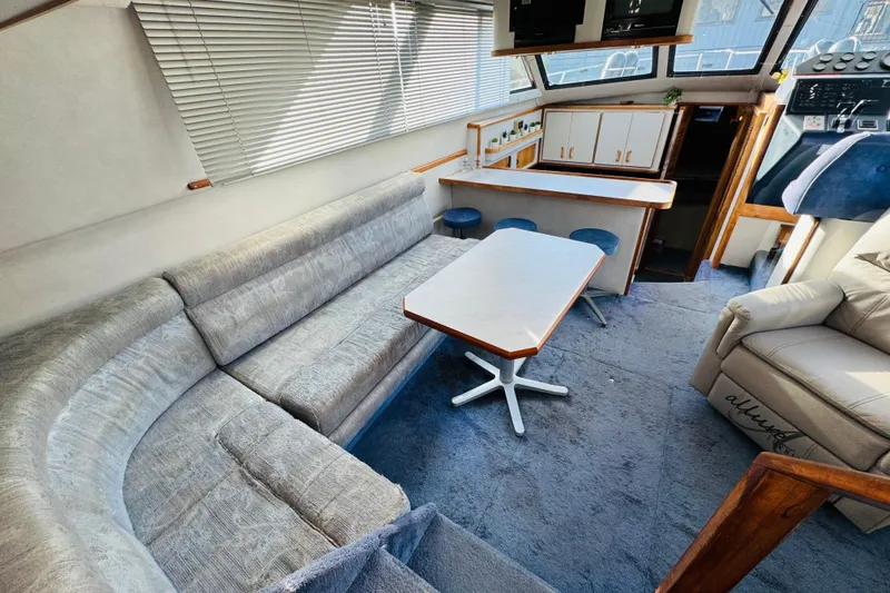 Slide: The Image of Interior of 1991 Sea Ray 380 Aft Cabin yacht with seating and dining area. - 22
