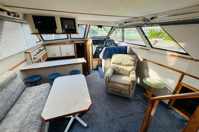 Slide: The Image of Interior of 1991 Sea Ray 380 Aft Cabin yacht with seating and helm. - 23