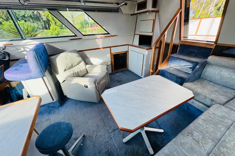 Slide: The Image of Interior of a 1991 Sea Ray 380 Aft Cabin with seating and table. - 27