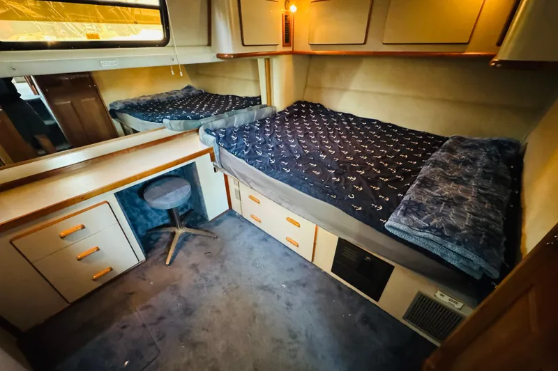 Slide: The Image of 1991 Sea Ray 380 Aft Cabin interior with twin beds and storage drawers. - 32