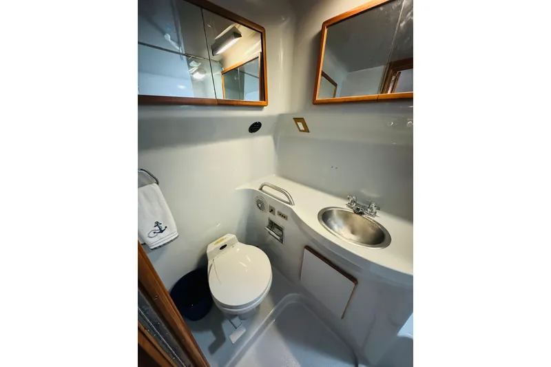Slide: The Image of Compact bathroom in 1991 Sea Ray 380 Aft Cabin yacht with sink, toilet, and mirror. - 35