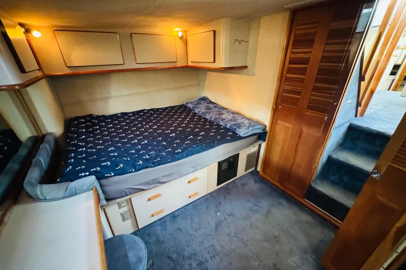 Slide: The Image of Cozy cabin interior of 1991 Sea Ray 380 Aft Cabin with bed and wooden accents. - 37