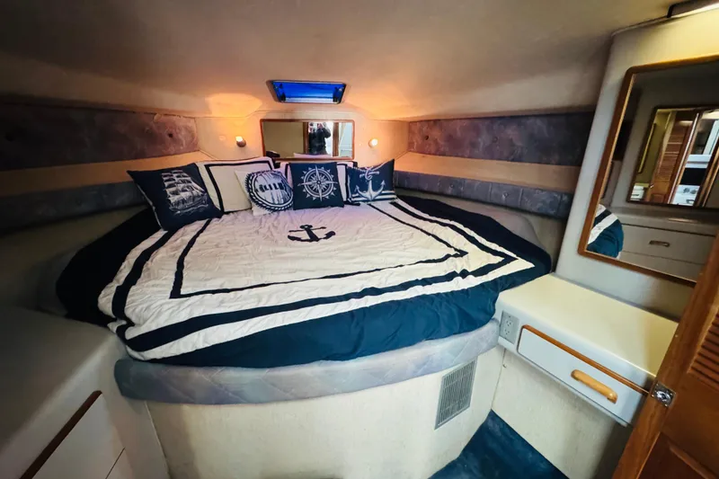 Slide: The Image of Cozy cabin interior of 1991 Sea Ray 380 Aft Cabin with nautical-themed bedding. - 38