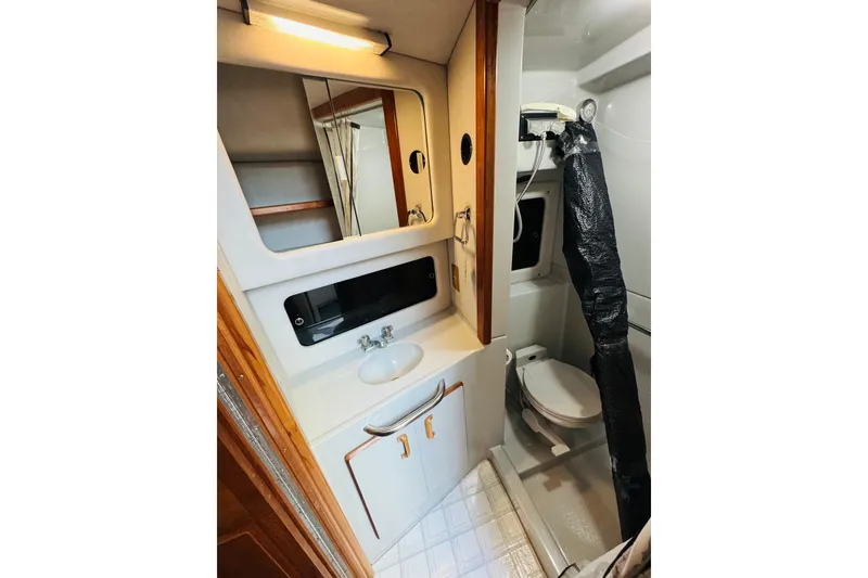 Slide: The Image of Bathroom interior of 1991 Sea Ray 380 Aft Cabin yacht, featuring sink and toilet. - 39