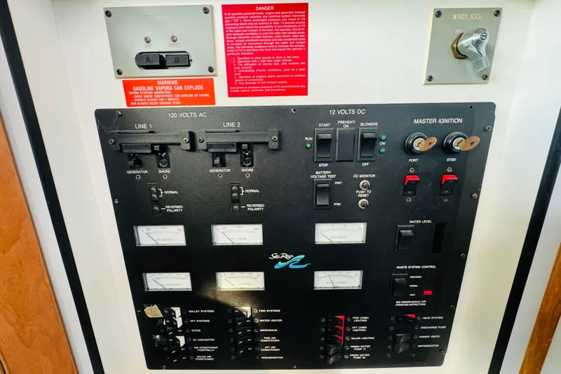 Slide: The Image of Control panel of a 1991 Sea Ray 380 Aft Cabin boat with various switches and gauges. - 40