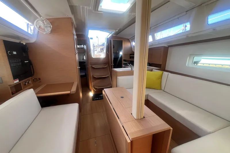 Slide: The Image of Interior of 2023 Jeanneau Sun Odyssey 380 sailboat, featuring modern seating and wood finishes. - 12