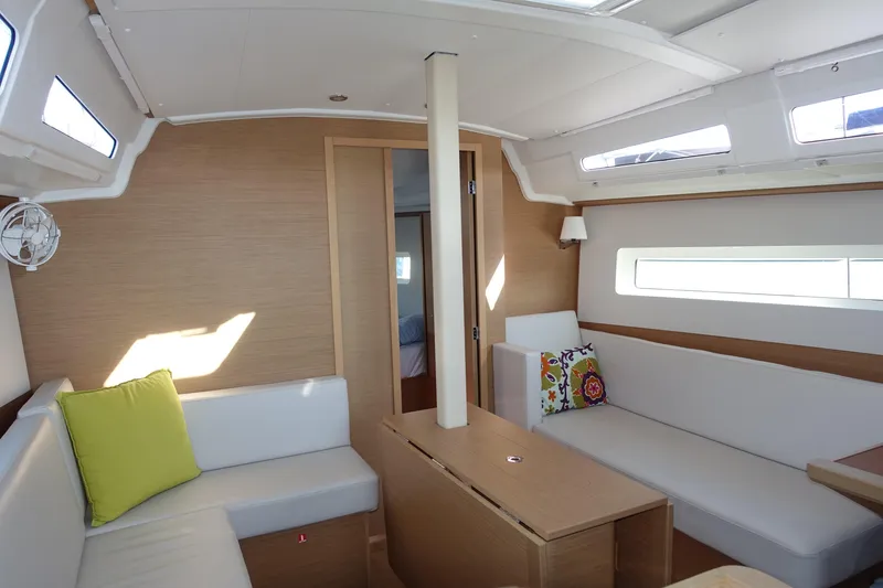 Slide: The Image of Interior of 2023 Jeanneau Sun Odyssey 380 yacht, featuring modern seating and natural light. - 13