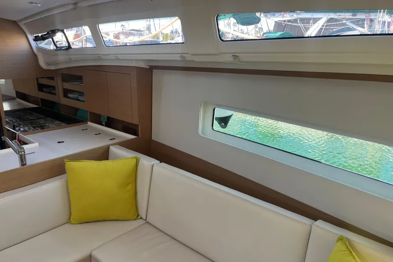 Slide: The Image of Interior of 2023 Jeanneau Sun Odyssey 380 yacht with modern kitchen and seating area. - 15