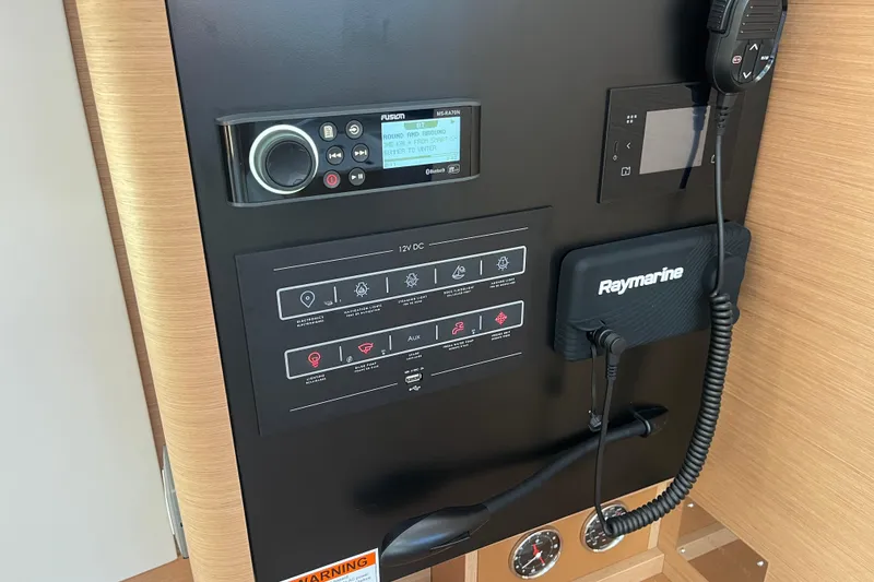 Slide: The Image of Control panel of 2023 Jeanneau Sun Odyssey 380 yacht with navigation and communication equipment. - 17