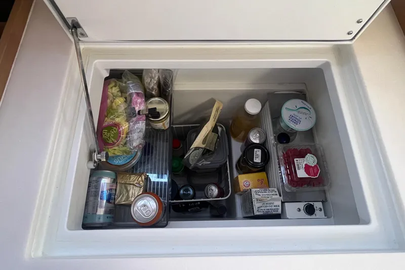 Slide: The Image of Jeanneau Sun Odyssey 380 fridge stocked with food and drinks. - 24