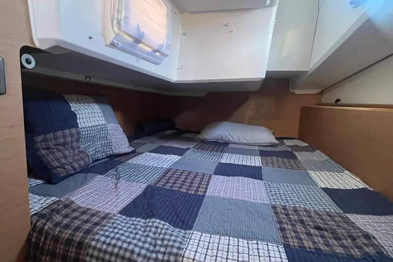 Slide: The Image of Cabin of Jeanneau Sun Odyssey 380, 2023, with checkered bedding. - 27