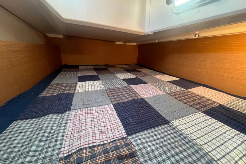 Slide: The Image of Interior of Jeanneau Sun Odyssey 380 with checkered bedding, year 2023. - 28