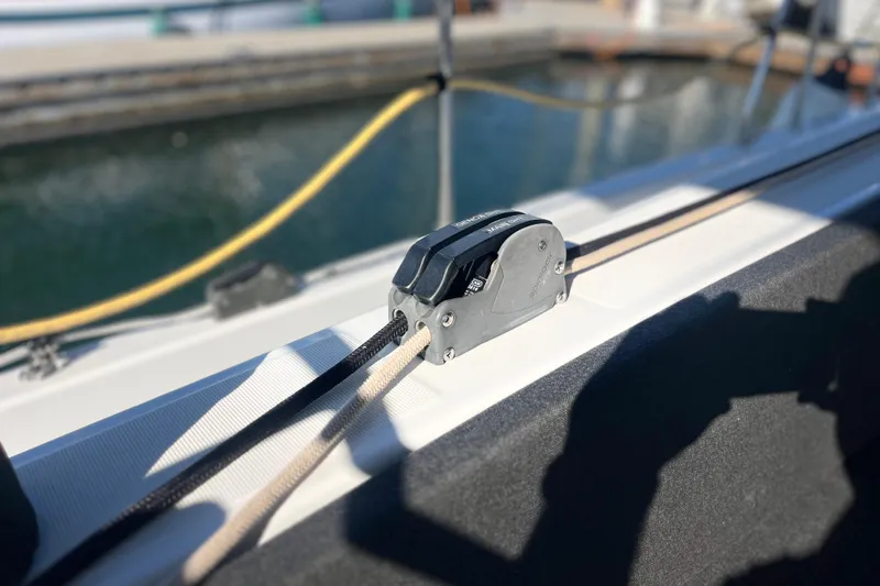 Slide: The Image of Close-up of a rope clutch on a 2023 Jeanneau Sun Odyssey 380 sailboat. - 41