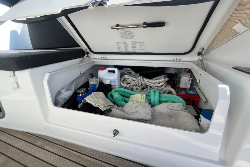 Slide: The Image of Storage compartment on a 2023 Jeanneau Sun Odyssey 380, containing ropes and maintenance supplies. - 43
