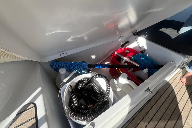 Slide: The Image of Storage compartment on 2023 Jeanneau Sun Odyssey 380 yacht with cleaning supplies and equipment. - 44