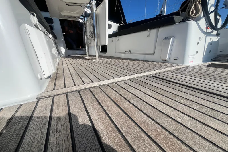Slide: The Image of 2023 Jeanneau Sun Odyssey 380 deck with wooden flooring and modern design elements. - 49