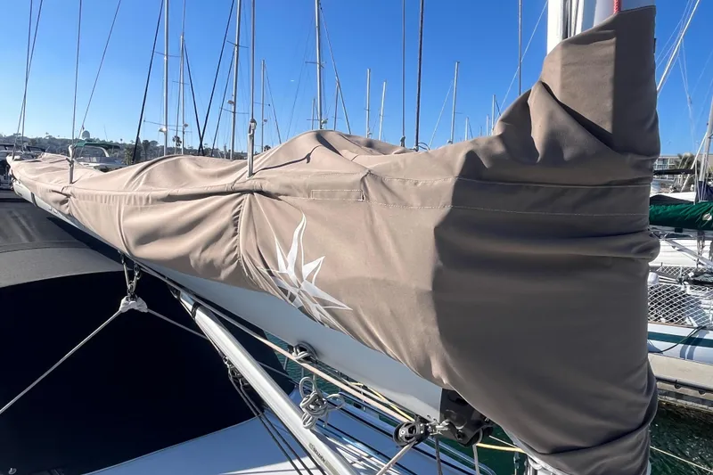 Slide: The Image of 2023 Jeanneau Sun Odyssey 380 sailboat mast with protective cover in marina. - 52
