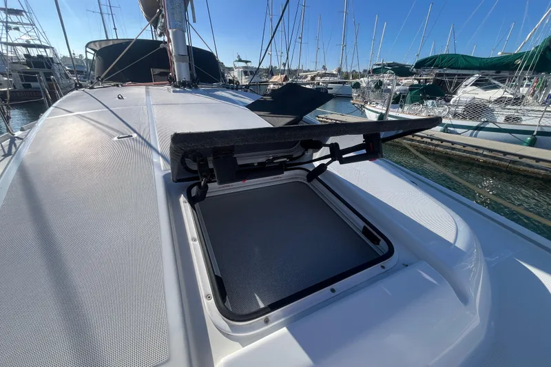 Slide: The Image of 2023 Jeanneau Sun Odyssey 380 yacht deck with open hatch in marina. - 55