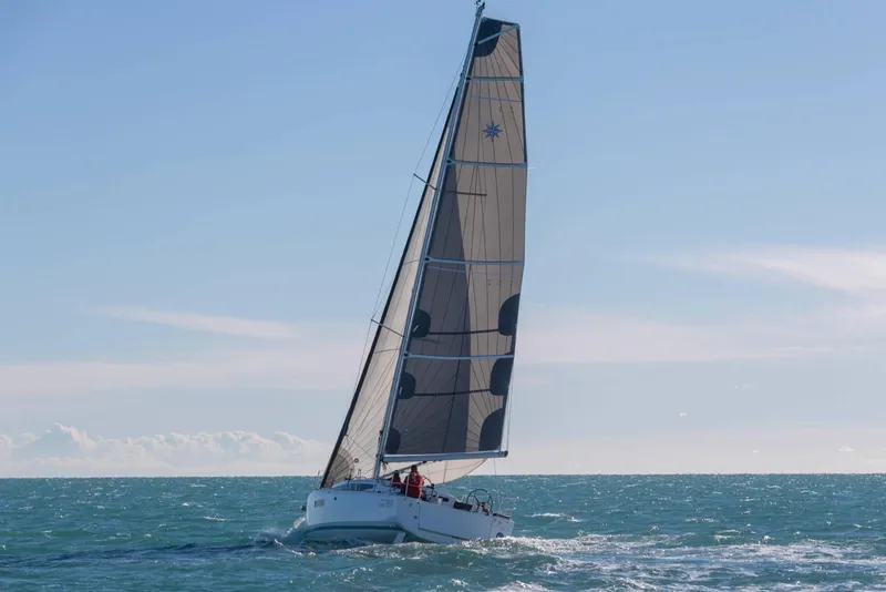 Slide: The Image of 2023 Jeanneau Sun Odyssey 380 sailing on open sea under clear blue sky. - 61