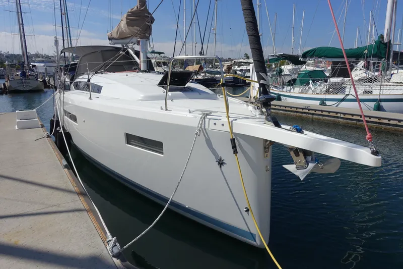 Slide: The Image of 2023 Jeanneau Sun Odyssey 380 yacht docked at marina, showcasing sleek design and modern features. - 64