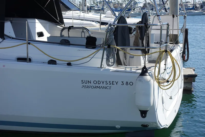 Slide: The Image of 2023 Jeanneau Sun Odyssey 380 yacht docked at marina, showcasing sleek design and performance features. - 66