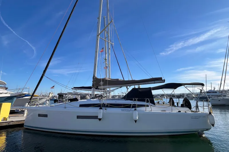Slide: The Image of 2023 Jeanneau Sun Odyssey 380 sailboat docked in a marina under a clear blue sky. - 68