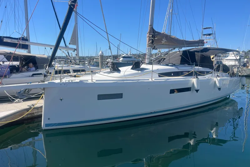Slide: The Image of 2023 Jeanneau Sun Odyssey 380 sailboat docked in a marina under clear blue skies. - 69