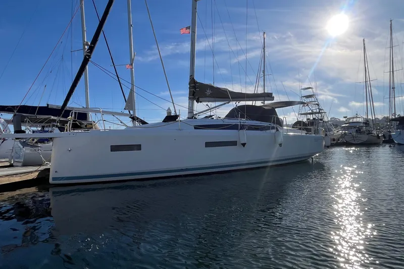 Slide: The Image of 2023 Jeanneau Sun Odyssey 380 sailboat docked in a sunny marina. - 70