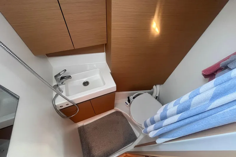 Slide: The Image of Compact bathroom in 2023 Jeanneau Sun Odyssey 380 yacht with sink, toilet, and shower. - 9