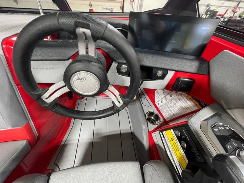Slide: The Image of Interior of 2026 Nautique Ski Nautique with steering wheel and display. - 11