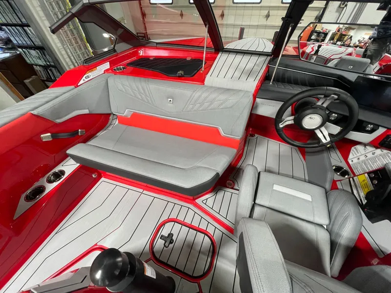 Slide: The Image of 2026 Nautique Ski Nautique interior with gray and red seating. - 12