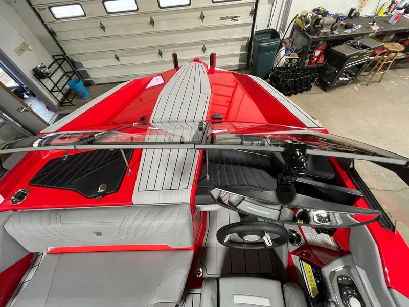 Slide: The Image of Interior view of a 2026 Nautique Ski Nautique boat in a workshop. - 13