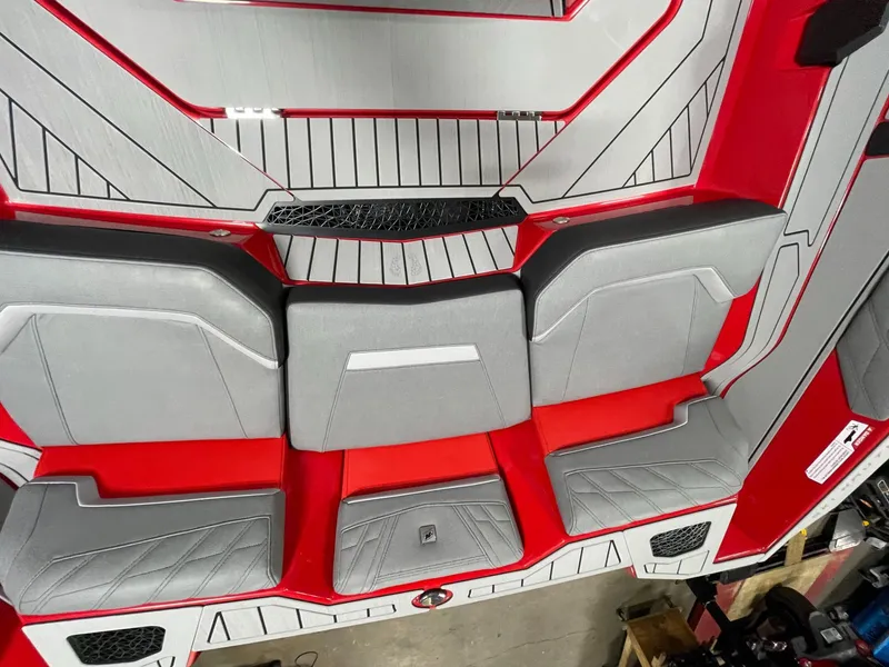 Slide: The Image of 2026 Nautique Ski Nautique interior with gray and red seating. - 16