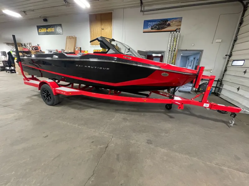 Slide: The Image of 2026 Nautique Ski Nautique boat on red trailer in warehouse. - 3