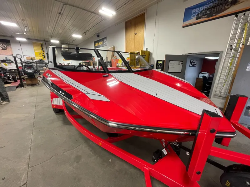 Slide: The Image of Red 2026 Nautique Ski Nautique boat in a workshop. - 5