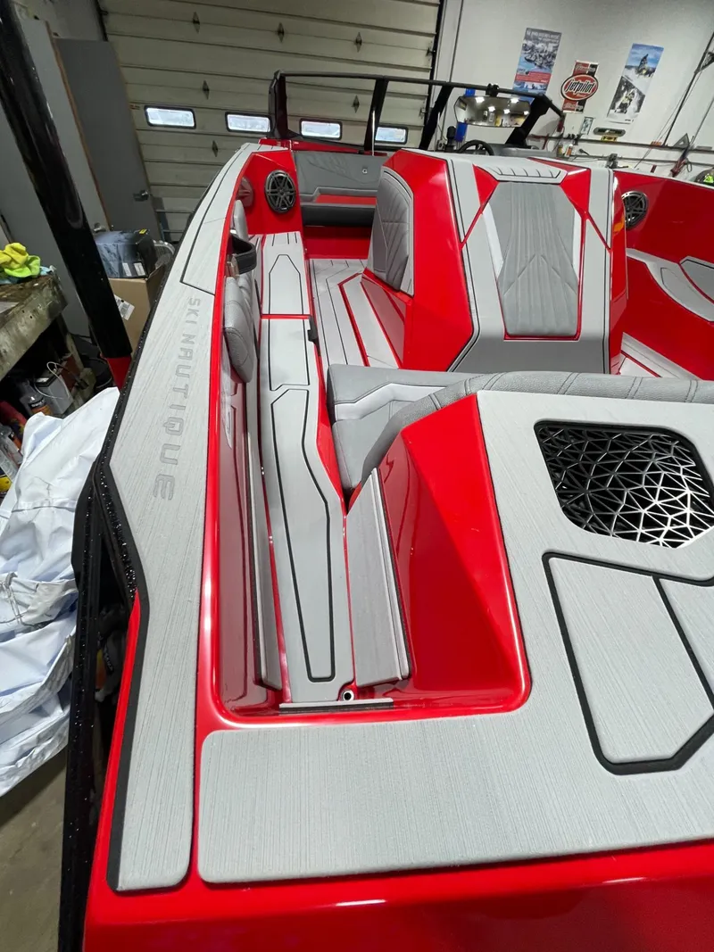 Slide: The Image of 2026 Nautique Ski Nautique boat, red and gray interior view. - 8