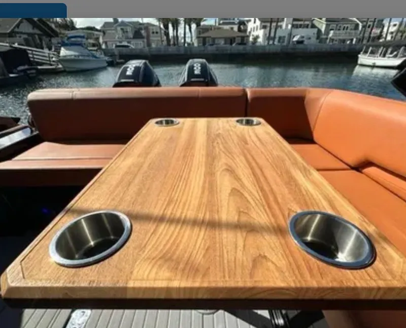 Slide: The Image of Interior of Cruisers Yachts 338 SS Outboard, wooden table with cup holders. - 15
