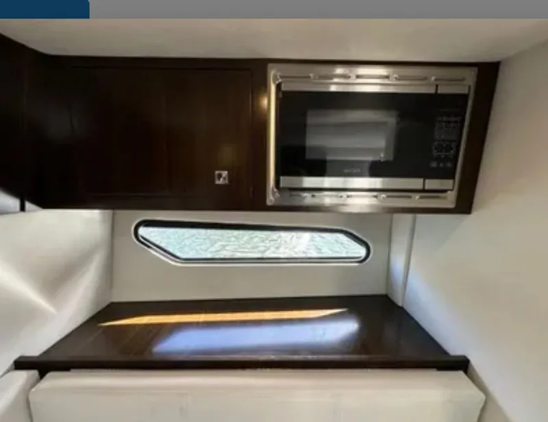 Slide: The Image of Interior of Cruisers Yachts 338 SS with microwave and window. - 16