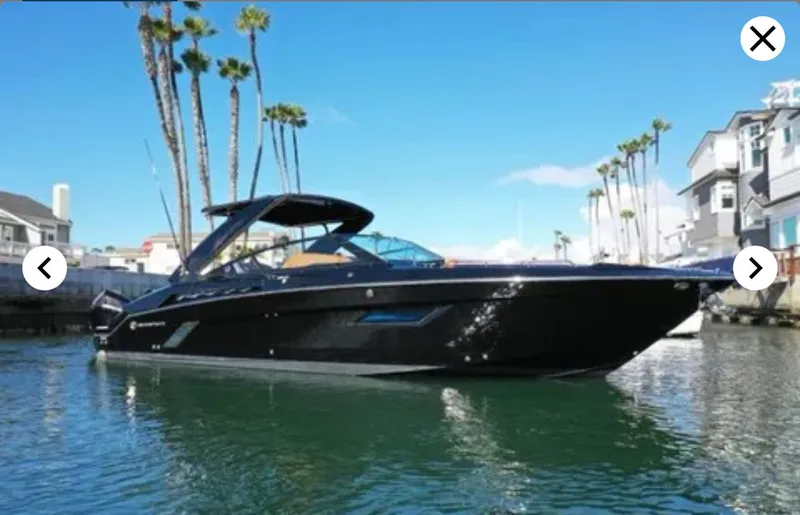 Slide: The Image of 2021 Cruisers Yachts 338 SS Outboard in sunny coastal setting. - 2