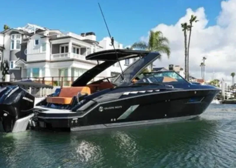 Slide: The Image of 2021 Cruisers Yachts 338 SS Outboard in a sunny harbor. - 24