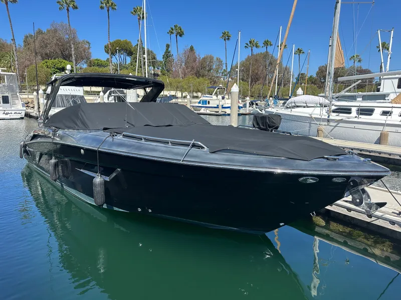 Slide: The Image of A black 2021 Cruisers Yachts 338 SS Outboard South Beach boat docked in the water. - 29