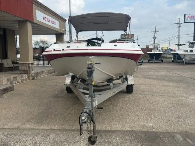 Slide: The Image of 2014 Hurricane SSR188 boat on trailer outside store. - 3