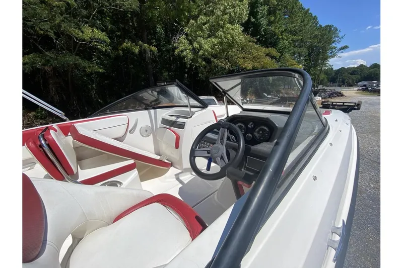Slide: The Image of 2016 Bayliner VR5 Bowrider OB interior with red and white seating, steering wheel, and dashboard. - 10