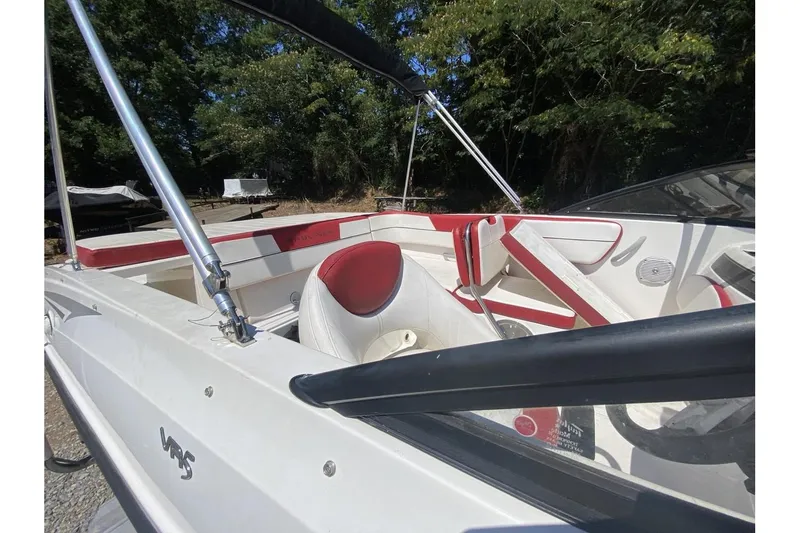 Slide: The Image of 2016 Bayliner VR5 Bowrider OB interior with red and white seating, outdoors. - 11
