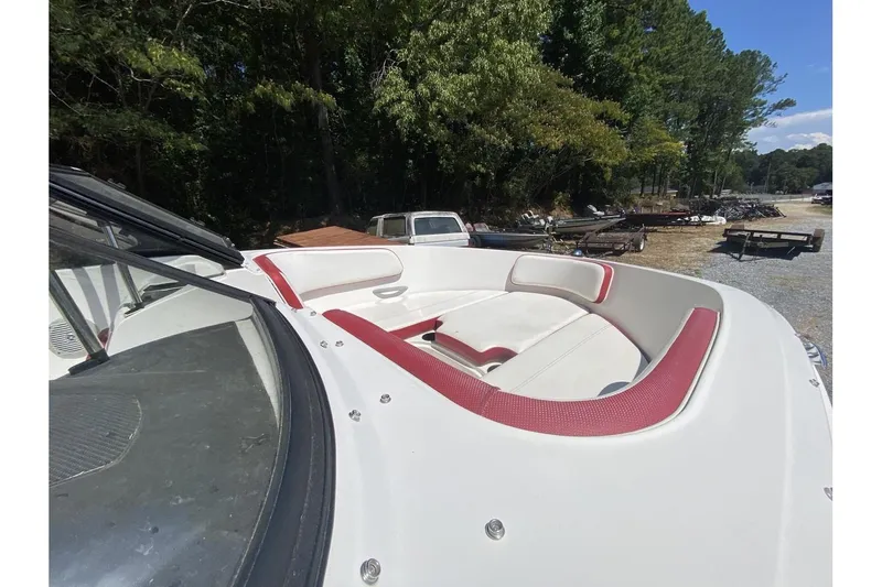 Slide: The Image of 2016 Bayliner VR5 Bowrider OB with red and white seating, parked outdoors. - 12