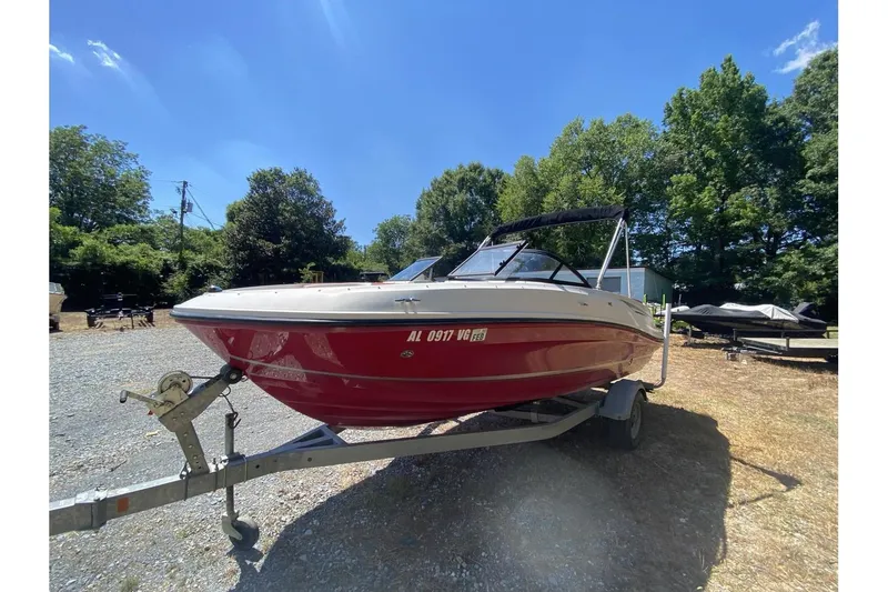 Slide: The Image of 2016 Bayliner VR5 Bowrider OB on trailer, parked outdoors under clear blue sky. - 6