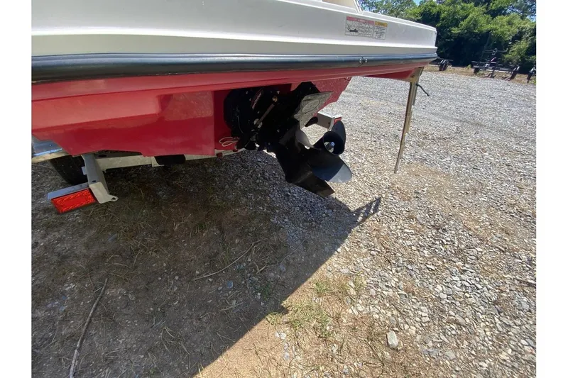 Slide: The Image of 2016 Bayliner VR5 Bowrider OB boat propeller and stern on gravel surface. - 8