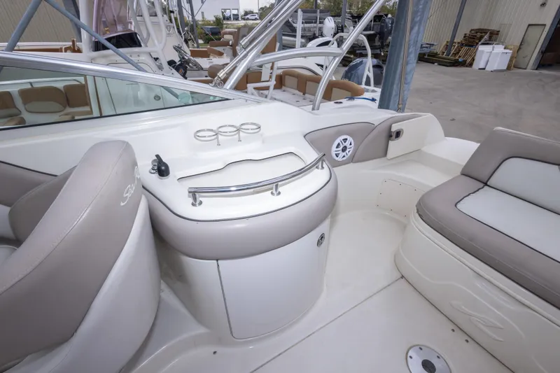 Slide: The Image of 2002 Sea Ray 270 Sundeck interior with seating and cup holders. - 10