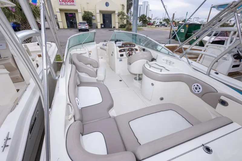 Slide: The Image of 2002 Sea Ray 270 Sundeck boat interior with beige seating and dashboard view. - 14